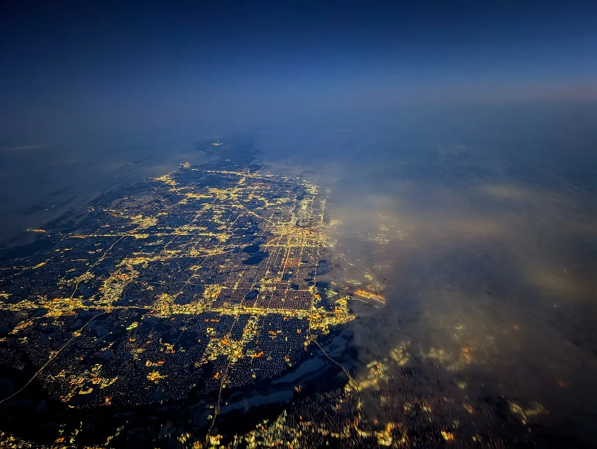 City lights appearing through clouds